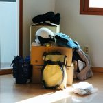 black and blue backpack on brown wooden table